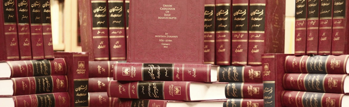 a stack of red books sitting on top of a wooden table