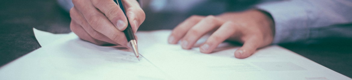 man writing on paper